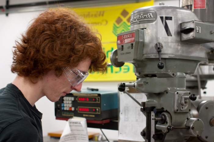 student working on machinery